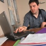 young man works on computer