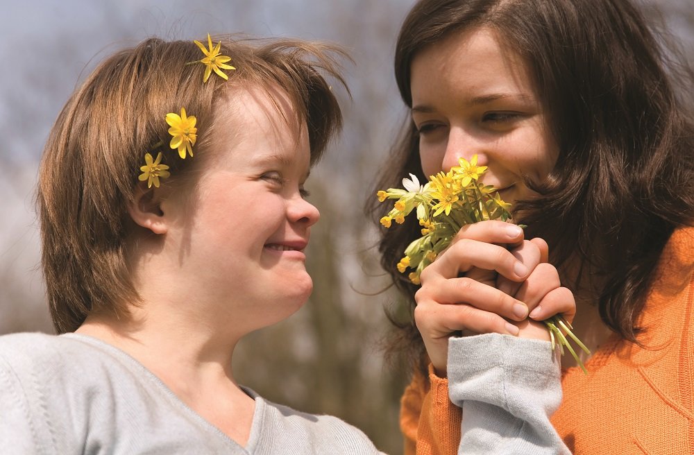 girl with down syndrome and flowers in her hair