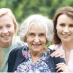 3 generations of women look to the camera