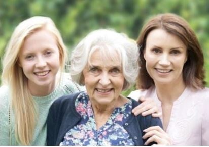 3 generations of women look to the camera