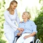 lady in wheelchair and carer walk outside
