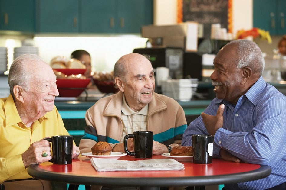 three elderly men laughing