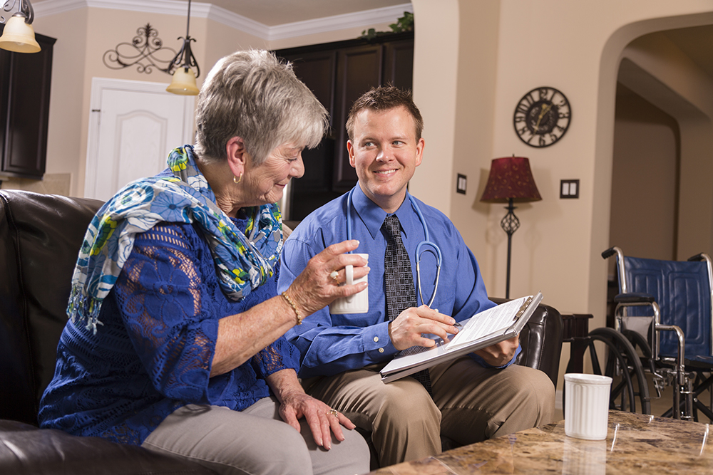 Doctor having chat with older lady