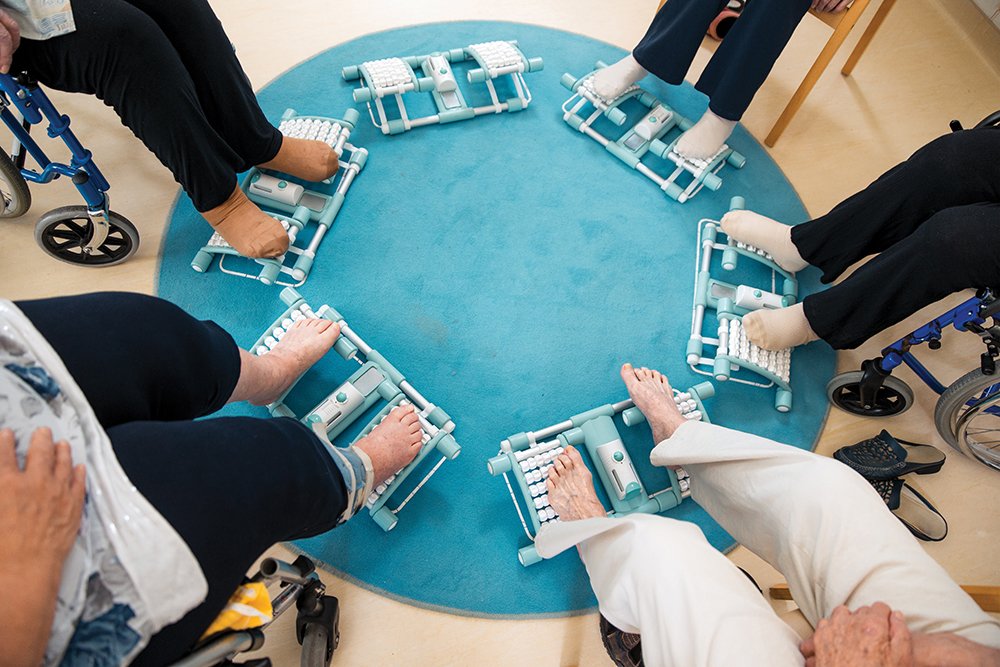 Seniors using a roller for foot massage