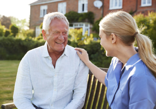 nurse talking to senior man