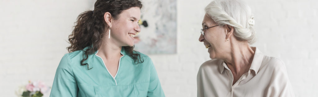 Two women are discussing and choosing a care home for their loved ones in a room.