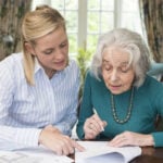 Professional helping older lady with estate planning