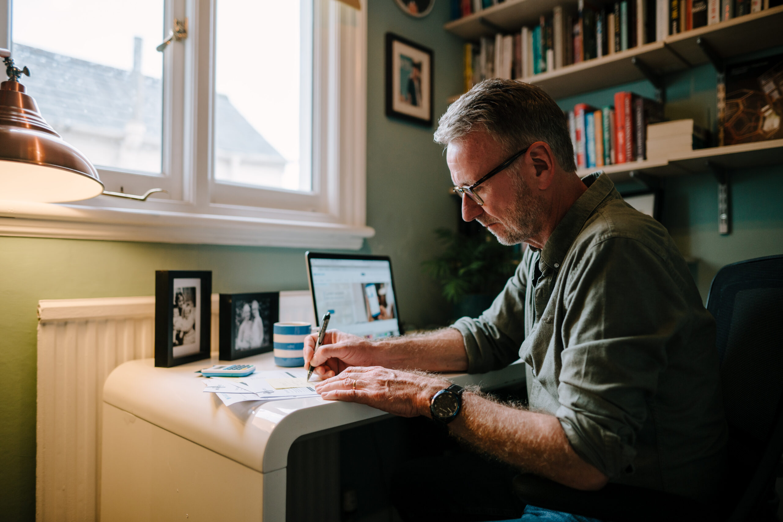 older man working at desk