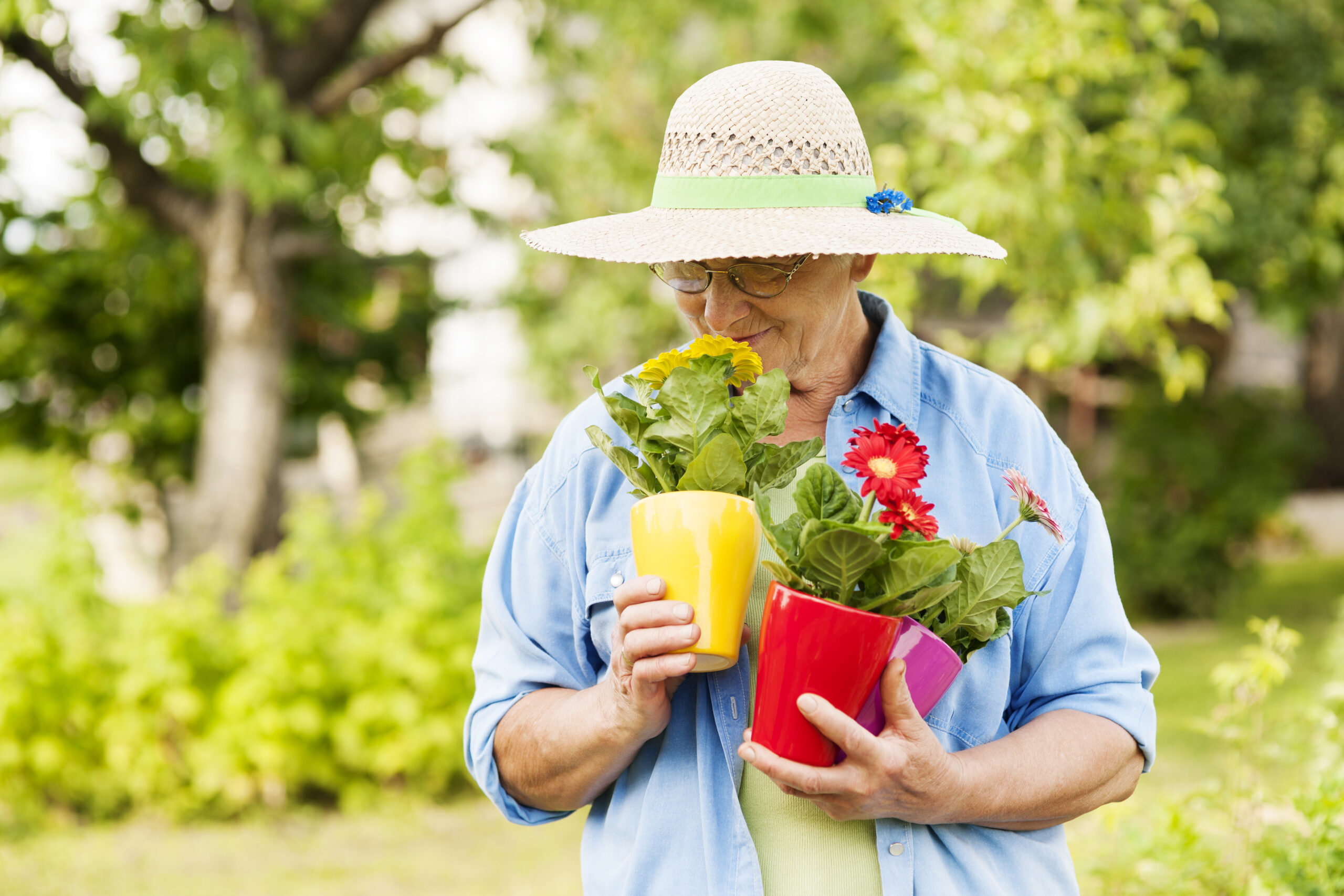 senior lady smelling flowers