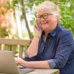 older lady on computer and phone