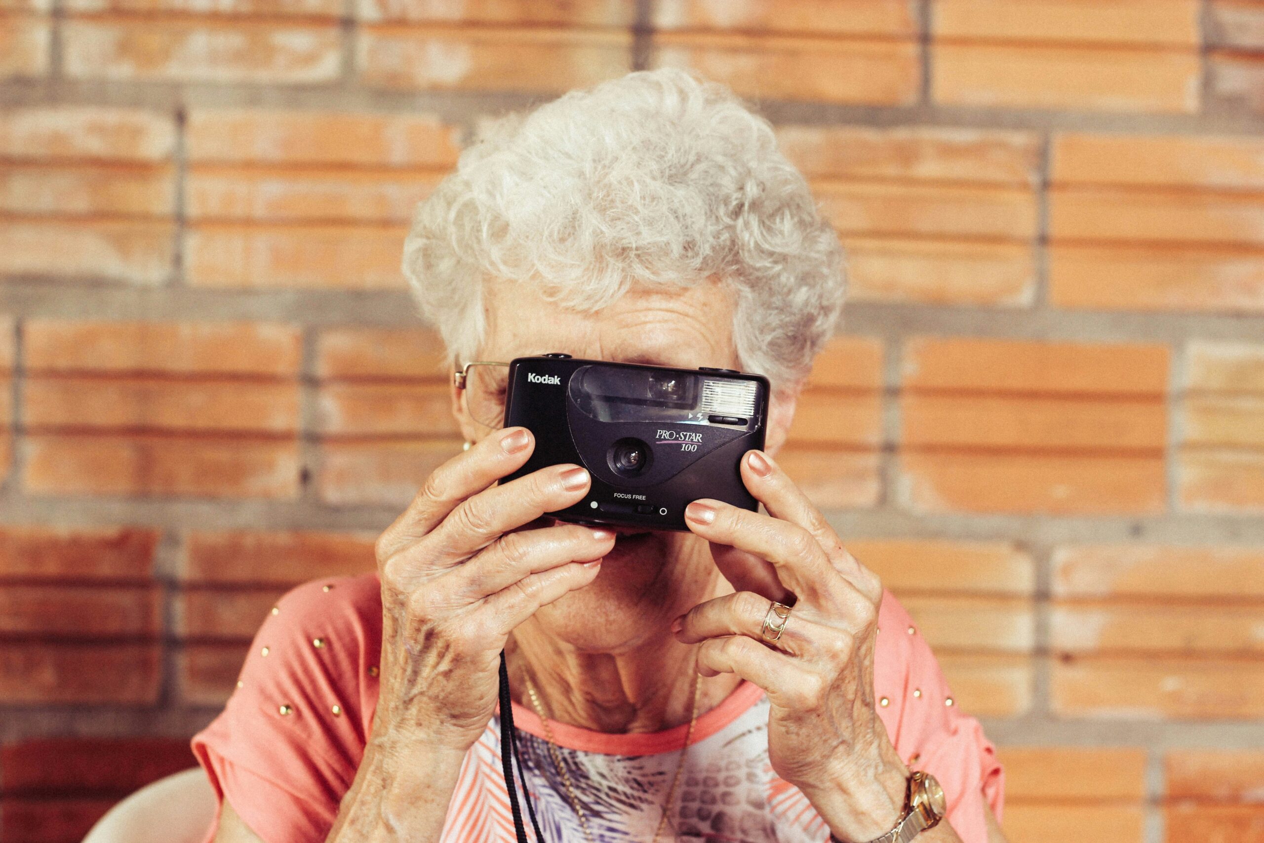older lady taking a picture with a camera