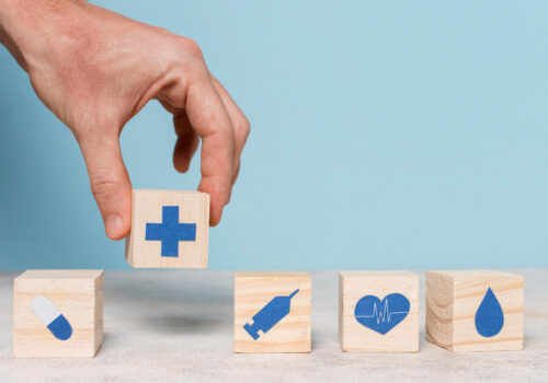 image of a hand with health care building blocks