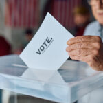 elderly man placing his vote