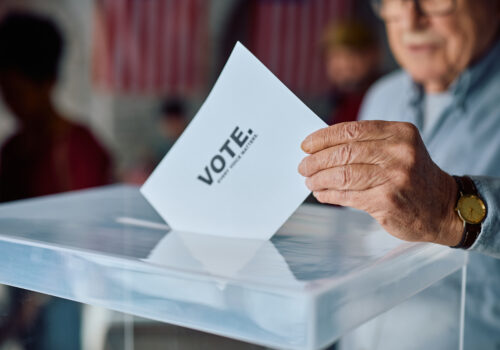 elderly man placing his vote