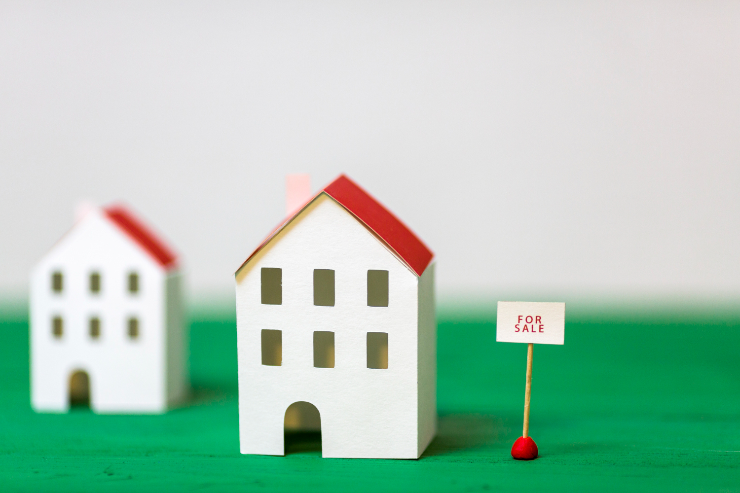 model house with for sale sign