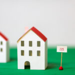 model house with for sale sign