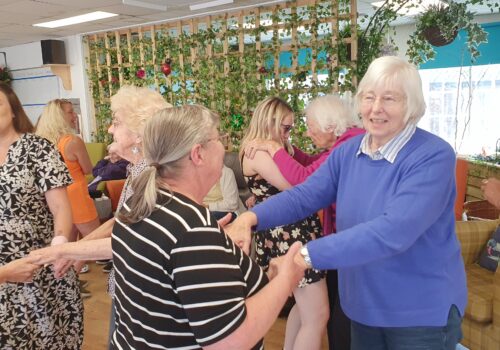 Participants at Old ilk Works Club (dementia day service) dancing