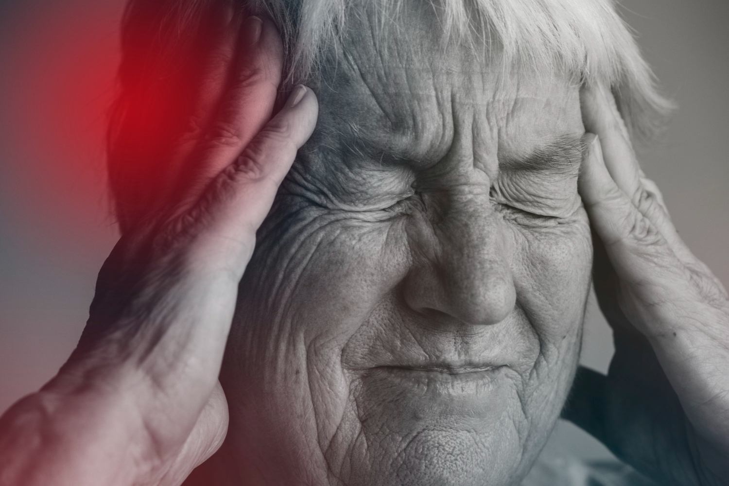 old lady clutching head experiencing stroke