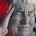old lady clutching head experiencing stroke