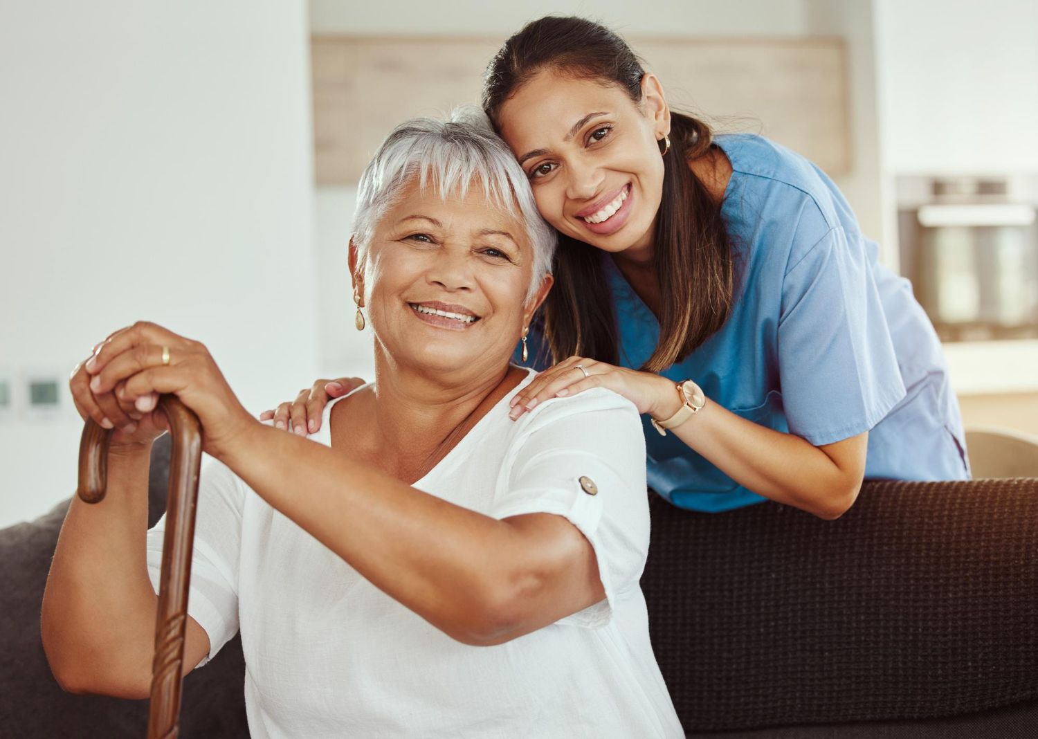 smiling lady and carer look at camera