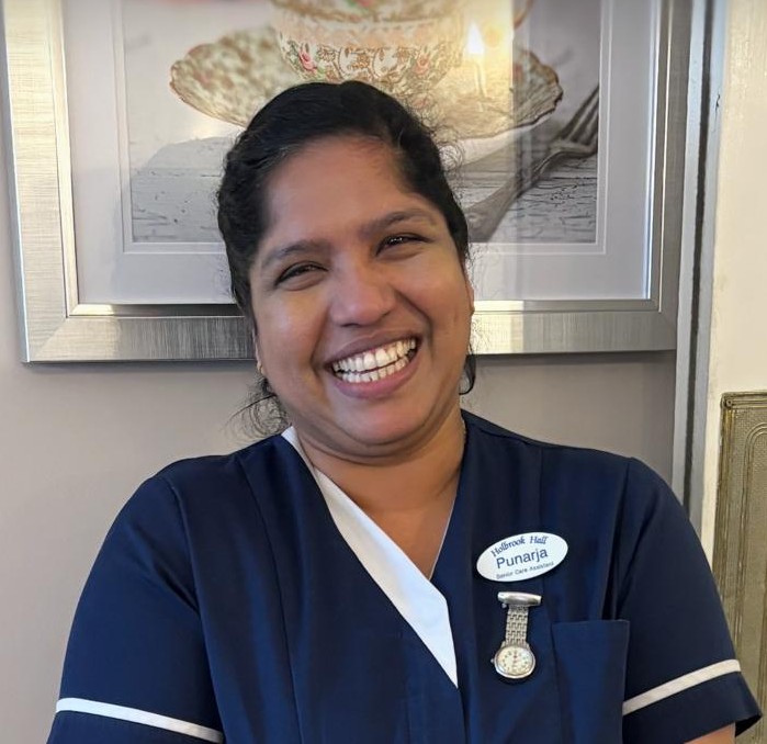 A woman smiling at the camera.
